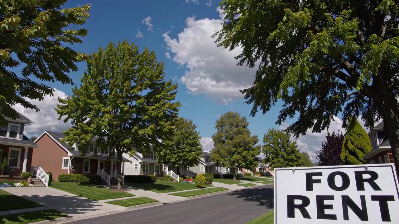 For Rent Sign on a Quiet Suburban Street with Houses