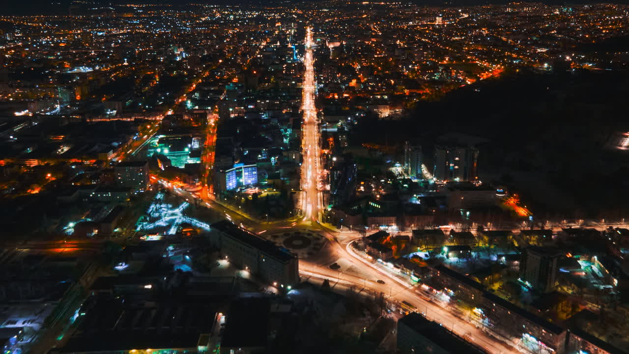 Aerial drone hyperlapse timelapse of moving cars in the city at night. Chisinau, Moldova