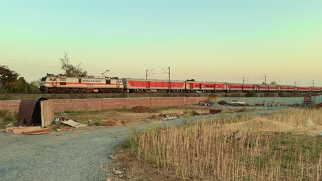 static shot of indian train is going through a village in india