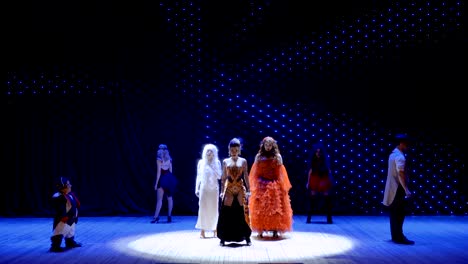 albino girl, fire girl and bearded girl performs song on stage in theatre