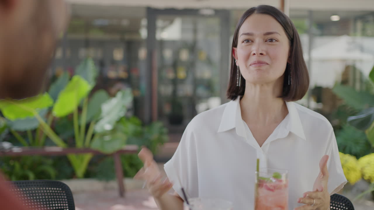 Woman Speaking with Colleague in Street Cafe