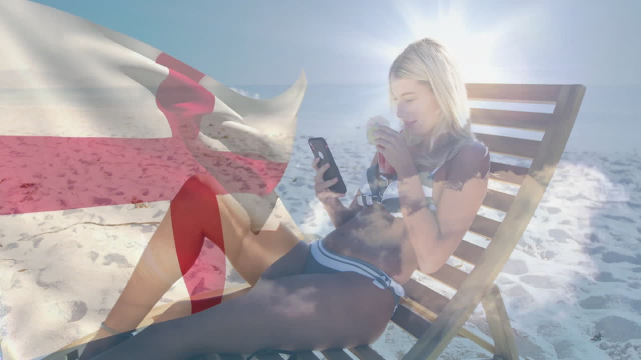 Relaxing on beach chair, woman with phone and drink with England flag animation