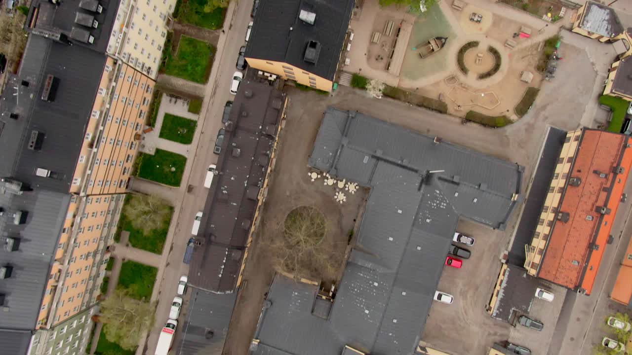 Top-down 90-degree aerial shot over Stockholm’s buildings and busy streets filled with ongoing traffic