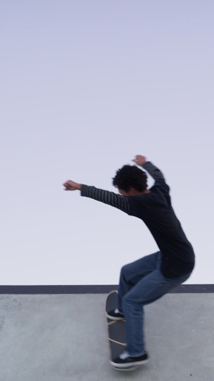 Young Skateboarder Performing a Trick on a Concrete Ramp