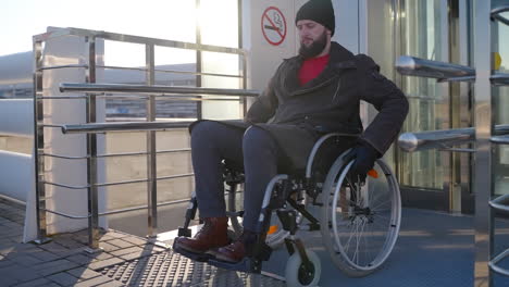 disabled person using wheelchair ramp at elevator