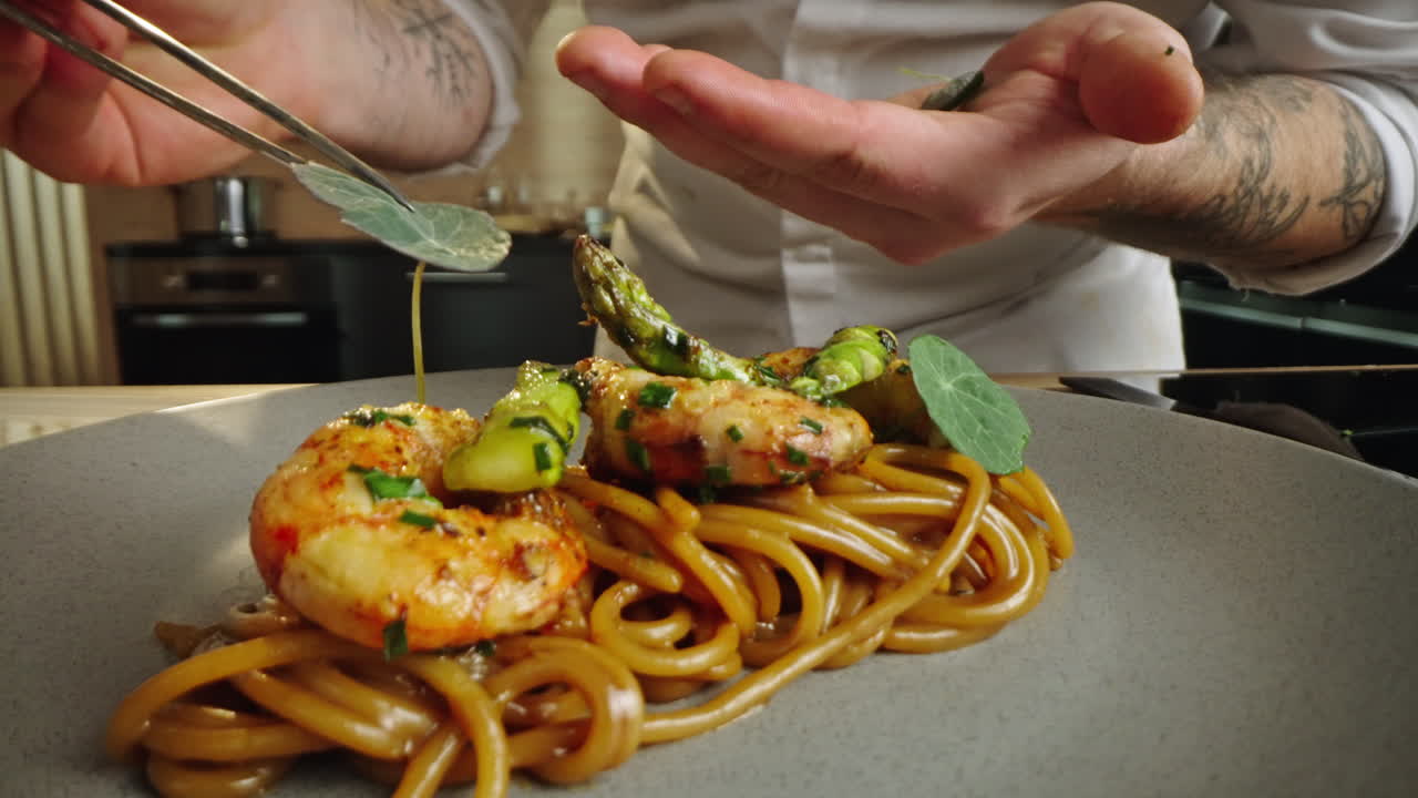 Chef plating gourmet seafood pasta dish