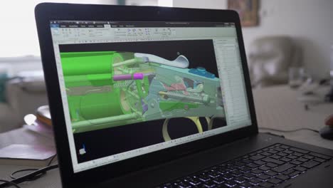 3d graphic designer is working on a rifle concept with a hi-tec mouse