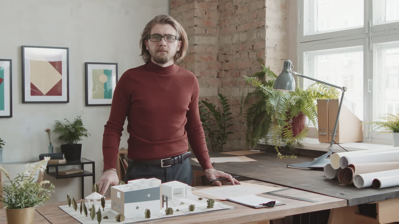 Portrait Of Male Architect Working On House Design In Office