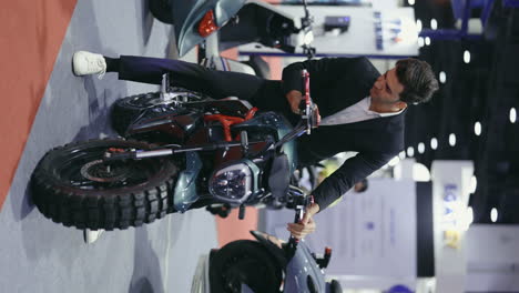 businessman inspecting electric motorcycle at trade show