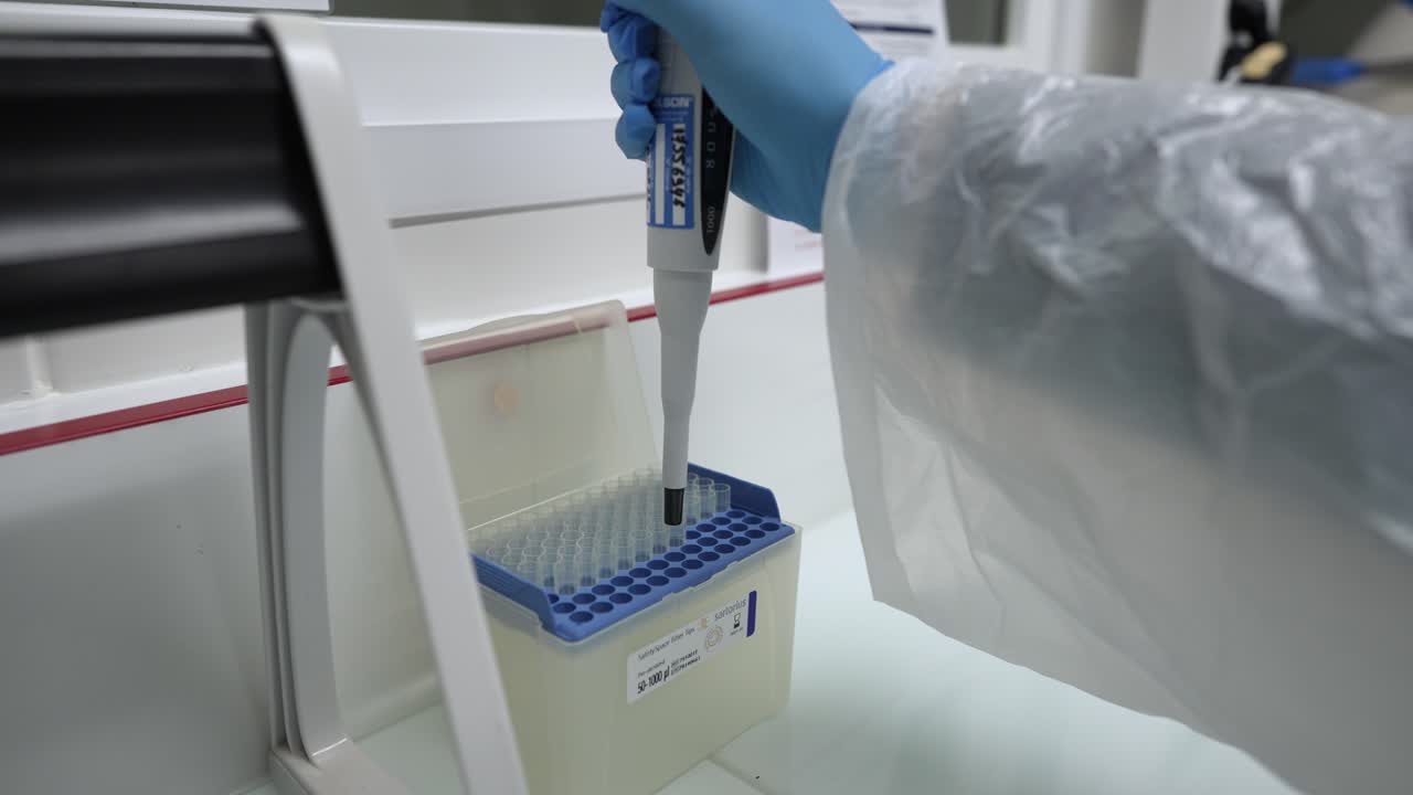 Scientist using a pipette to handle samples in a laboratory