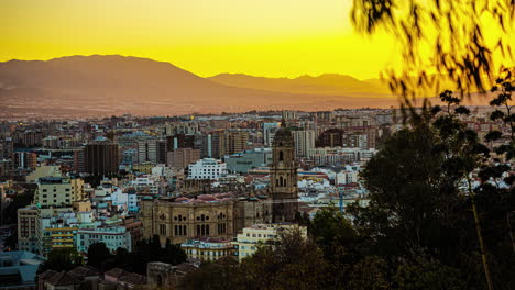 malaga, spain during a golden sunrise - time lapse