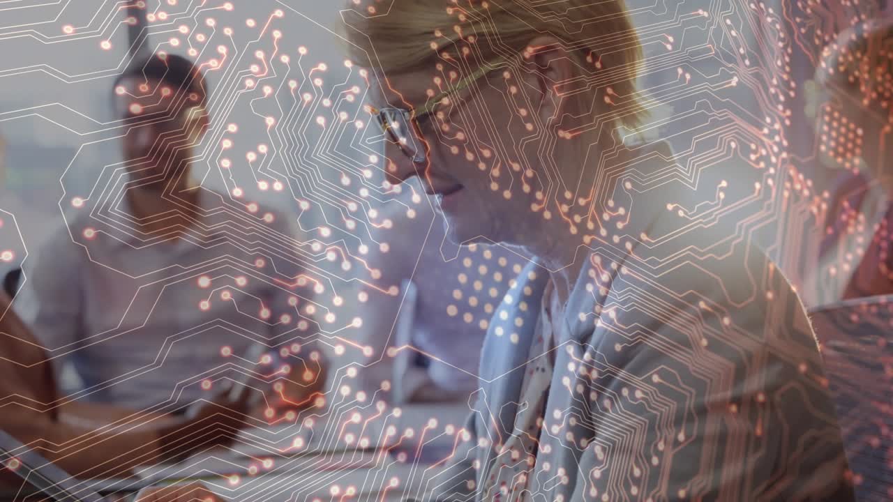 Woman starting typing on laptop and activating circuit graphic over business meeting sharing data