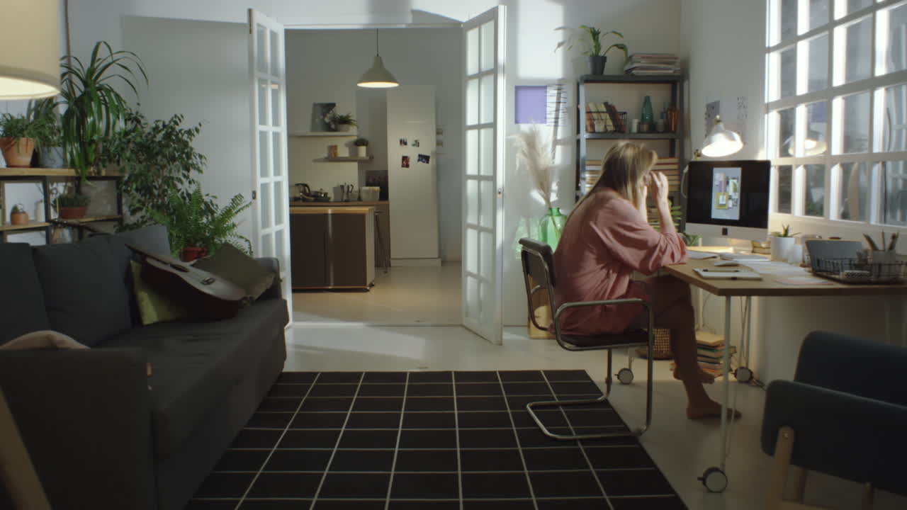 집에서 컴퓨터에서 작업하는 여자