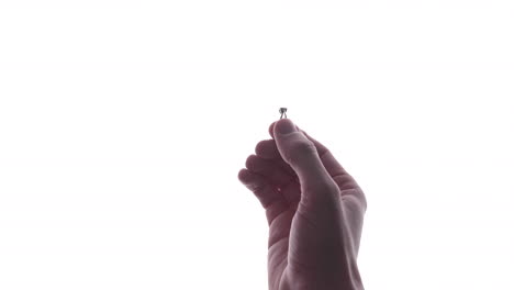 Hand-Putting-Ring-On-Girlfriend's-Finger-During-Romantic-Marriage-Proposal-In-White-Background