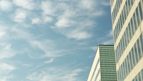 close-up of a modern office building facade with reflective windows and architectural details