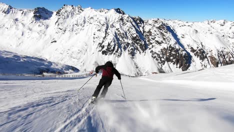 full speed action skiing of young male skier, nice rhythmic short ski turns on a steep ski slope in austria