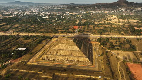 pyramid of the sun, sunlit by the morning sunlight, in teotihuacan, mexico - aerial view