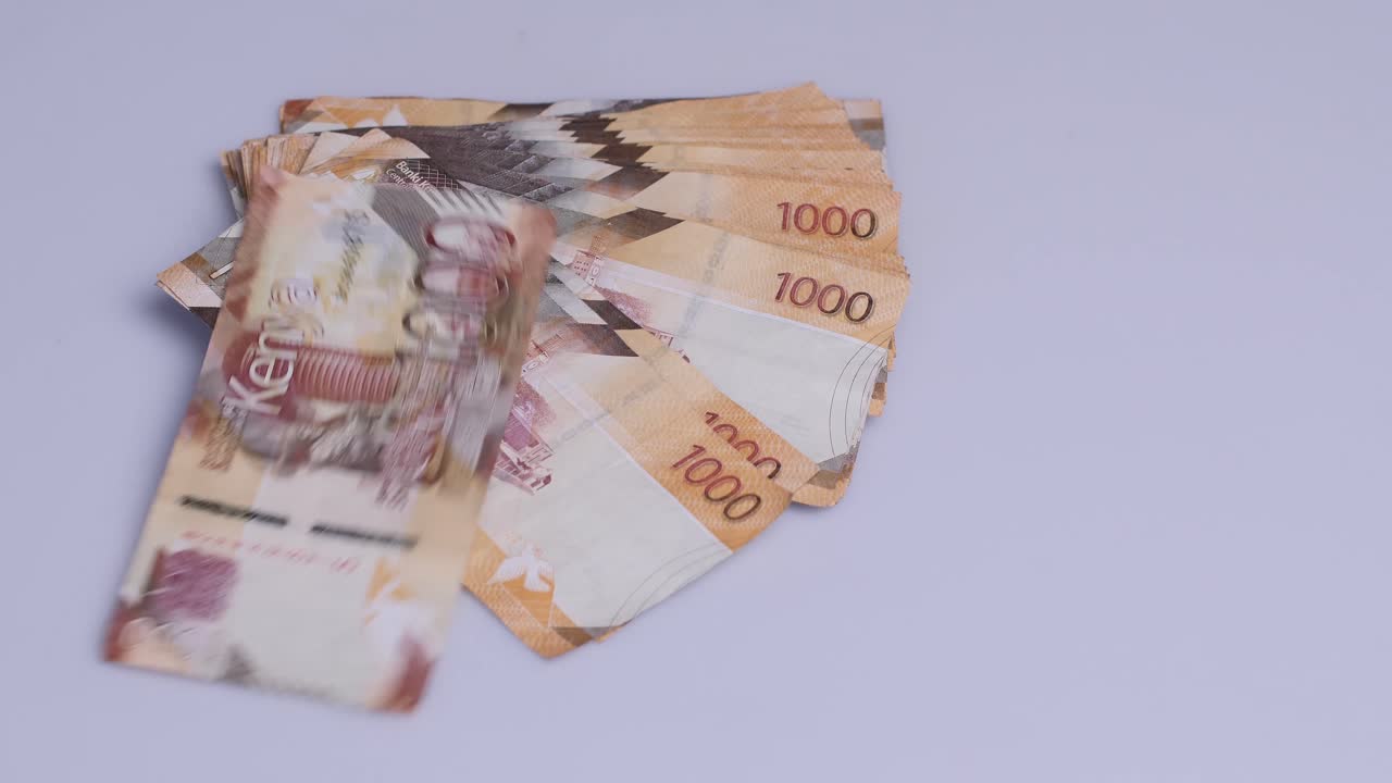 Kenyan shillings currency money dropping on the table then scattering. Kenyan shillings currency