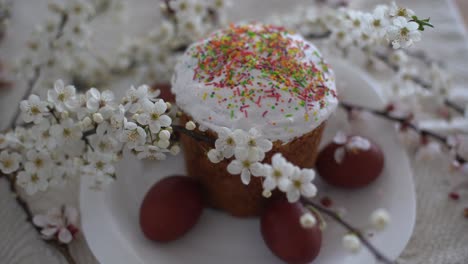 happy easter. easter cake, a branch of mimosa and eggs on a canvas napkin.