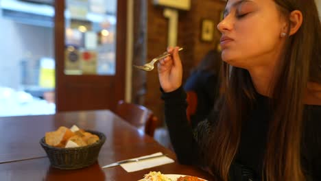 woman enjoying a meal in a restaurant