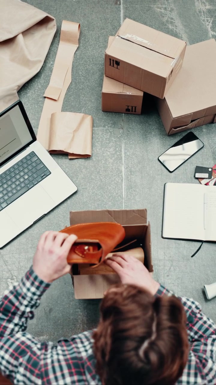 Small Business Owner Packing Orders in Warehouse