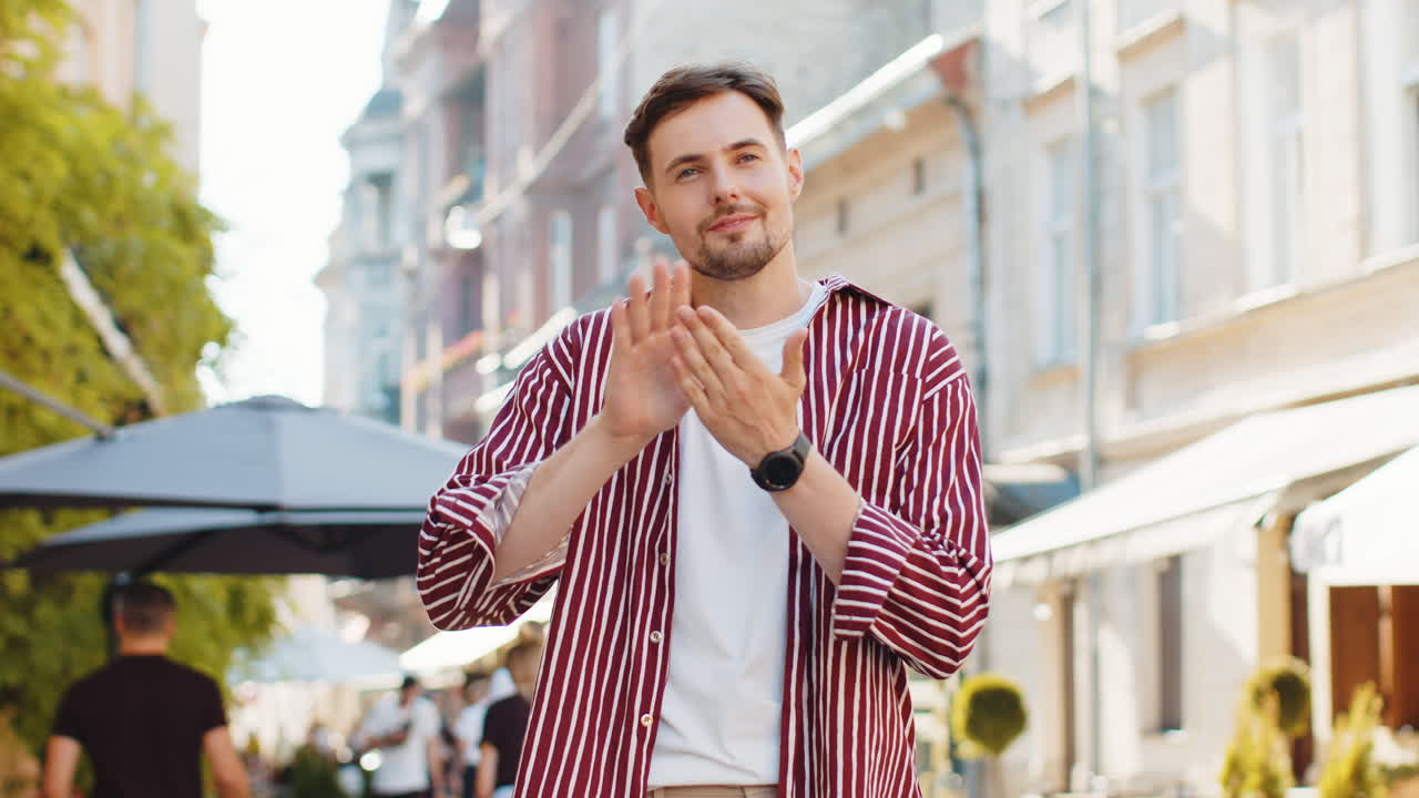 Cheerful rich man showing wasting throwing money win lottery share celebrate on urban city street