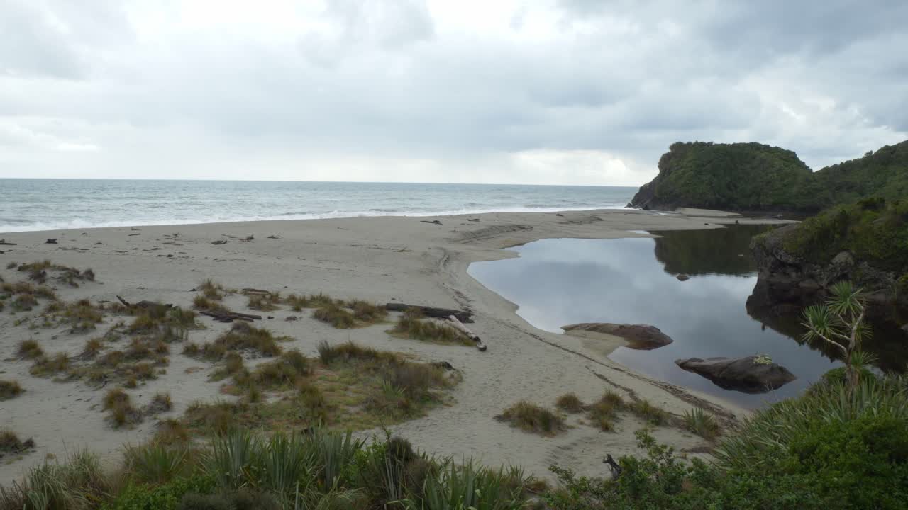Beach With A River In Ship Creek - Tauparikaka Marine Reserve, Haast, New Zealand. - wide shot