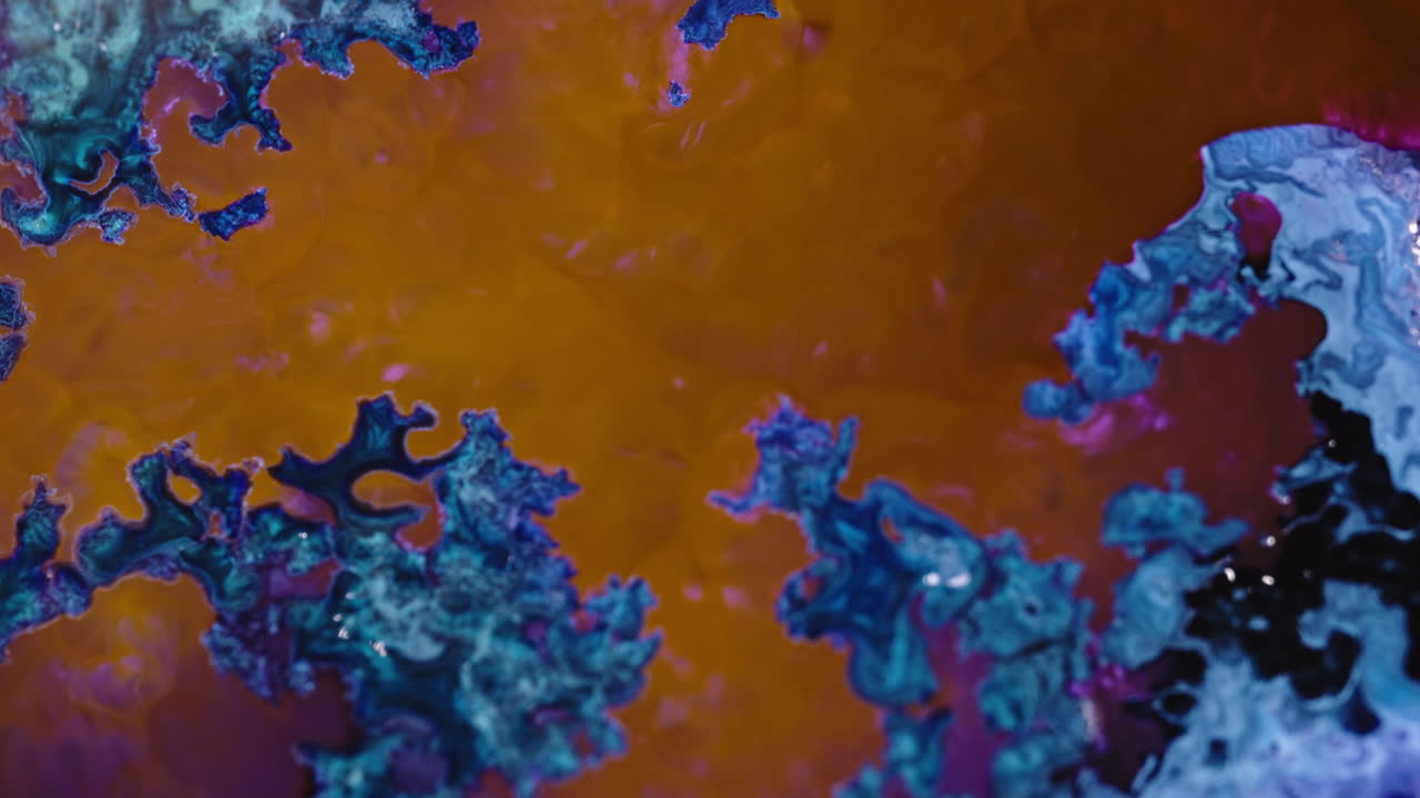 Abstract close-up of swirling black and blue liquid patterns in motion, resembling organic shapes