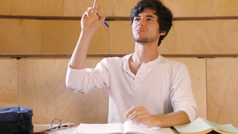 handsome student taking notes