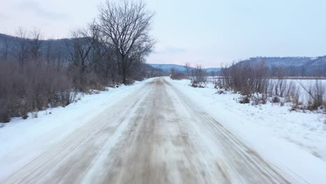 snowy country road through winter landscape