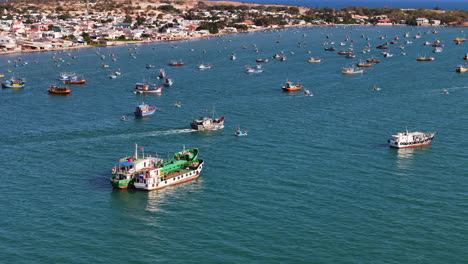 commercial fishing boat leaving the busy sea port in phan thiet city