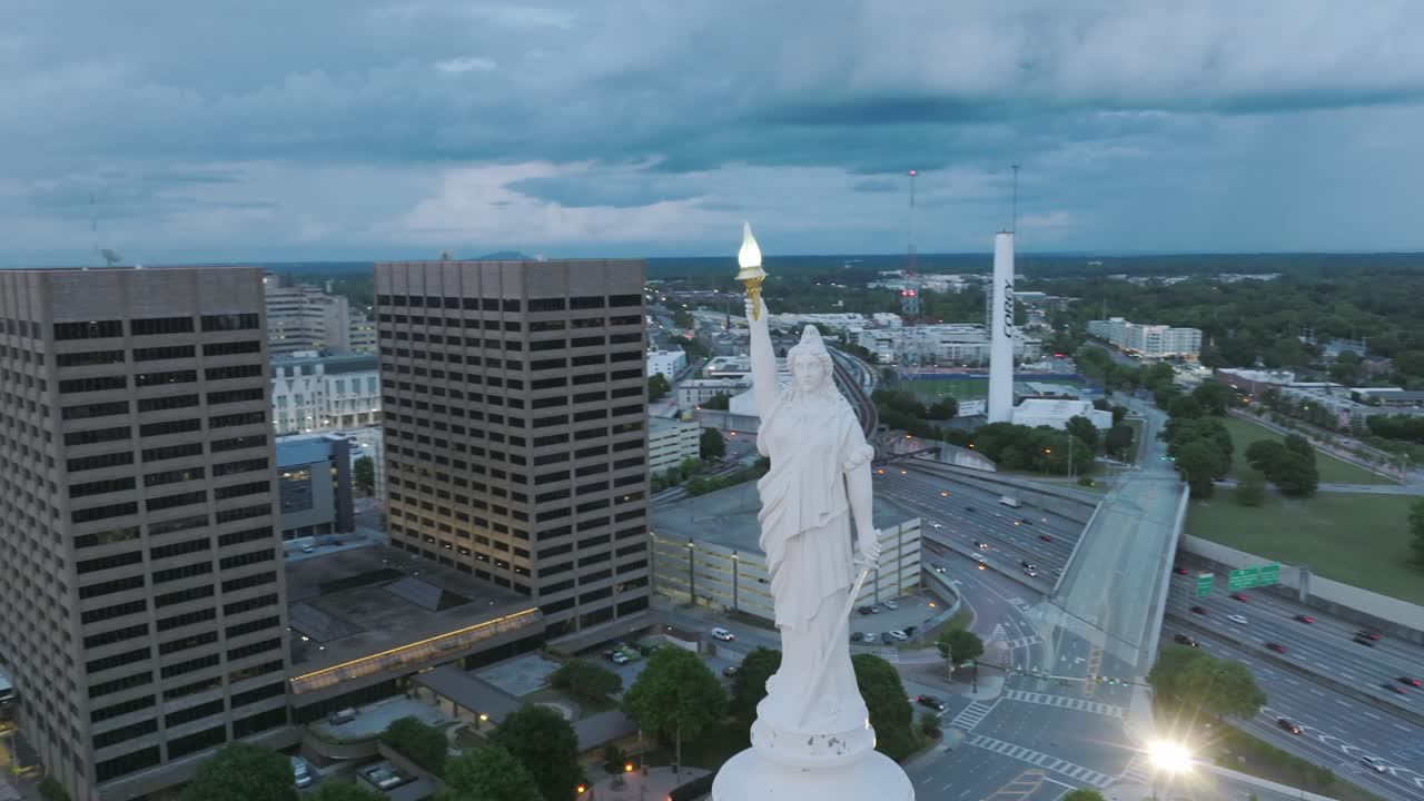 Slow aerial wide rotating footage of the statue on top of the Capitol Building in downtown Atlanta, Georgia