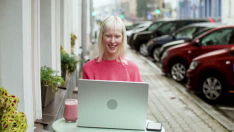 Blond-woman-videocalling-at-the-terrace