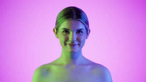 joyful cute young woman sticks tongue out and smiles, double light studio shot