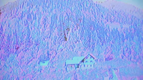 Old-school-VHS-glitch-of-static-circuit-bending-on-haunted-house-on-hillside-of-forest