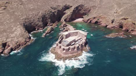 aerial view looking down orbiting historic coastal fort of sao joao baptista das berlengas ocean landmark, portugal