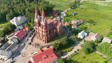 sveksna township and iconic red brick church with two towers, aerial view