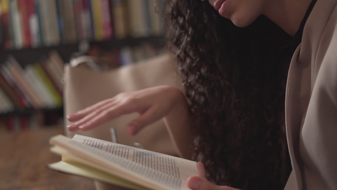 Woman reading and taking notes in a library