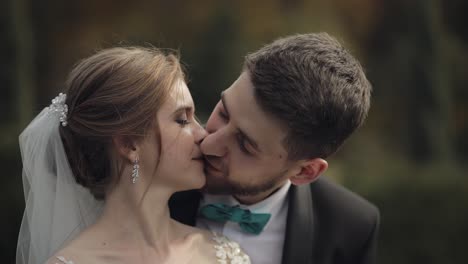 newlyweds. caucasian groom with bride in the park. wedding couple. happy family