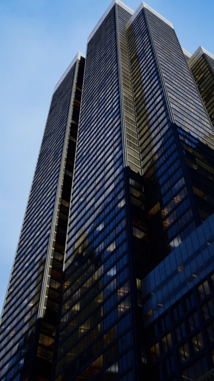 High rise buildings reach towards the evening sky in a bustling city