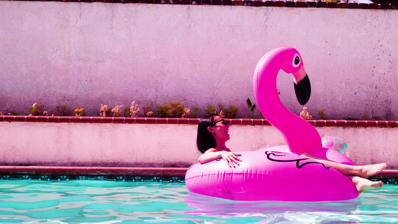 Female floating in the pool enjoying the sun