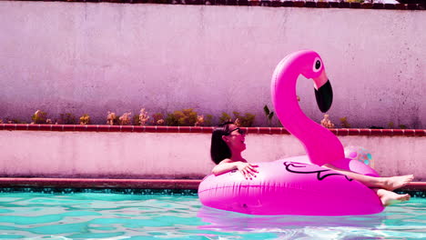 female floating in the pool enjoying the sun