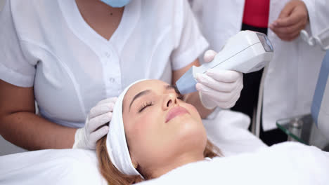 Beautiful shot of a female doctor and her assistant doing a beauty treatment to a beautiful young woman lying on a stretcher.
