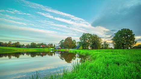 Timelapse-of-clouds-moving-over-a-during-sunset-with-a-rainbow-appearing