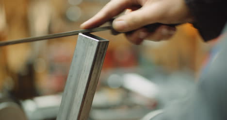 industry worker sanding metal with metal file 4