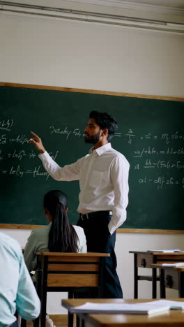 teacher explaining math to students in a classroom