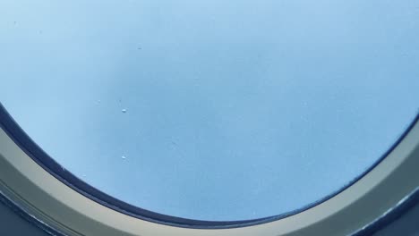 cinematic wide shot of a flurry of air bubbles from the porthole as a submarine rises to the surface of the ocean off the coast of hawai'i