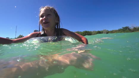 girl swims in the sea on a rubber ring