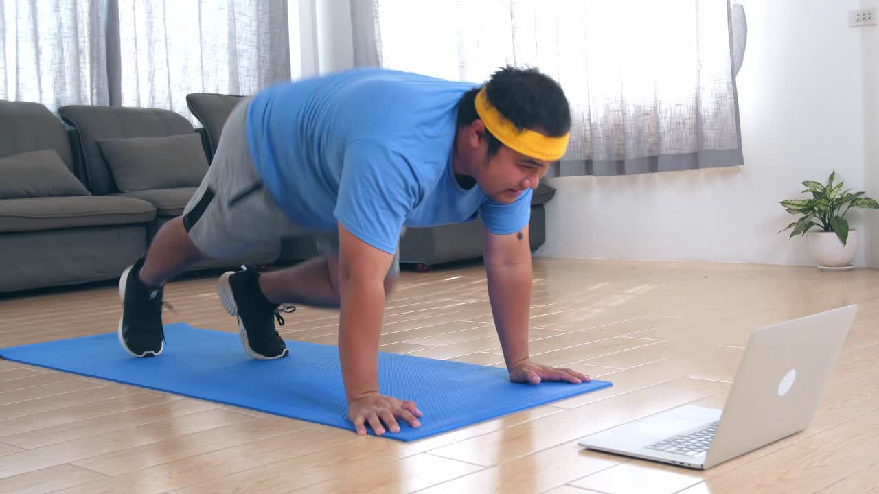 Obese Man Doing Online Workout at Home