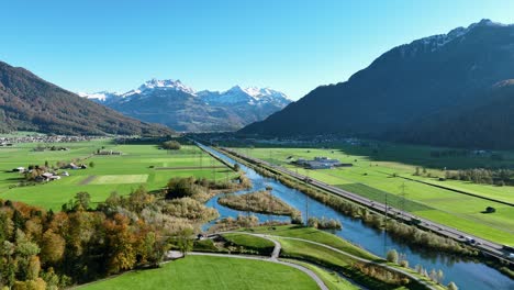 Aerial-view-of-beautiful-Swiss-mountainside-above-Linth-river-in-Switzerland